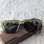 MOSCOT Transparent Olive Green Rectangular Sunglasses with Dark Lenses